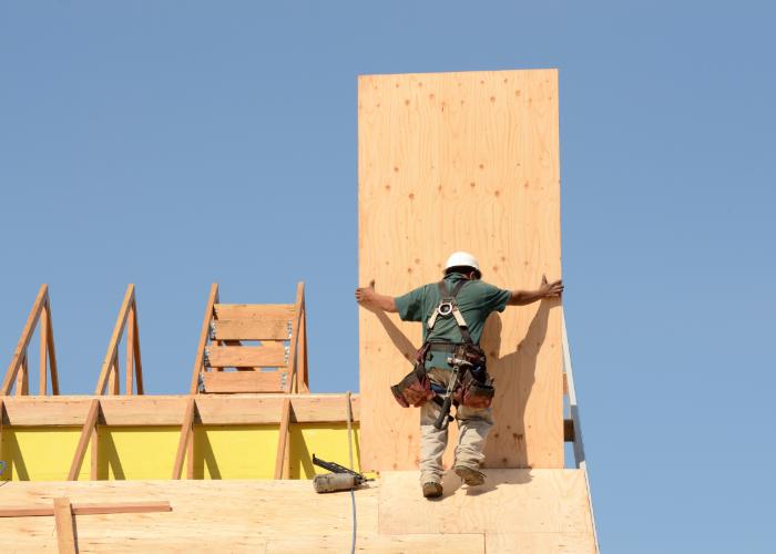 A contractor installing decking for roof replacement in San Diego.